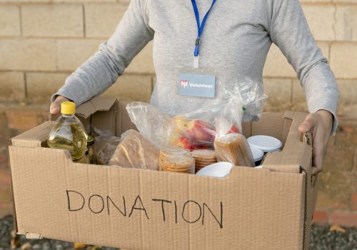 close-up-volunteer-holding-box-with-food